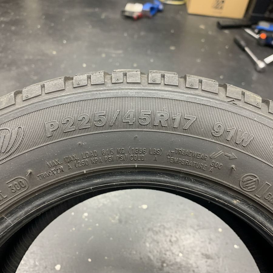 Close-up of a tire sidewall showing size markings and ratings